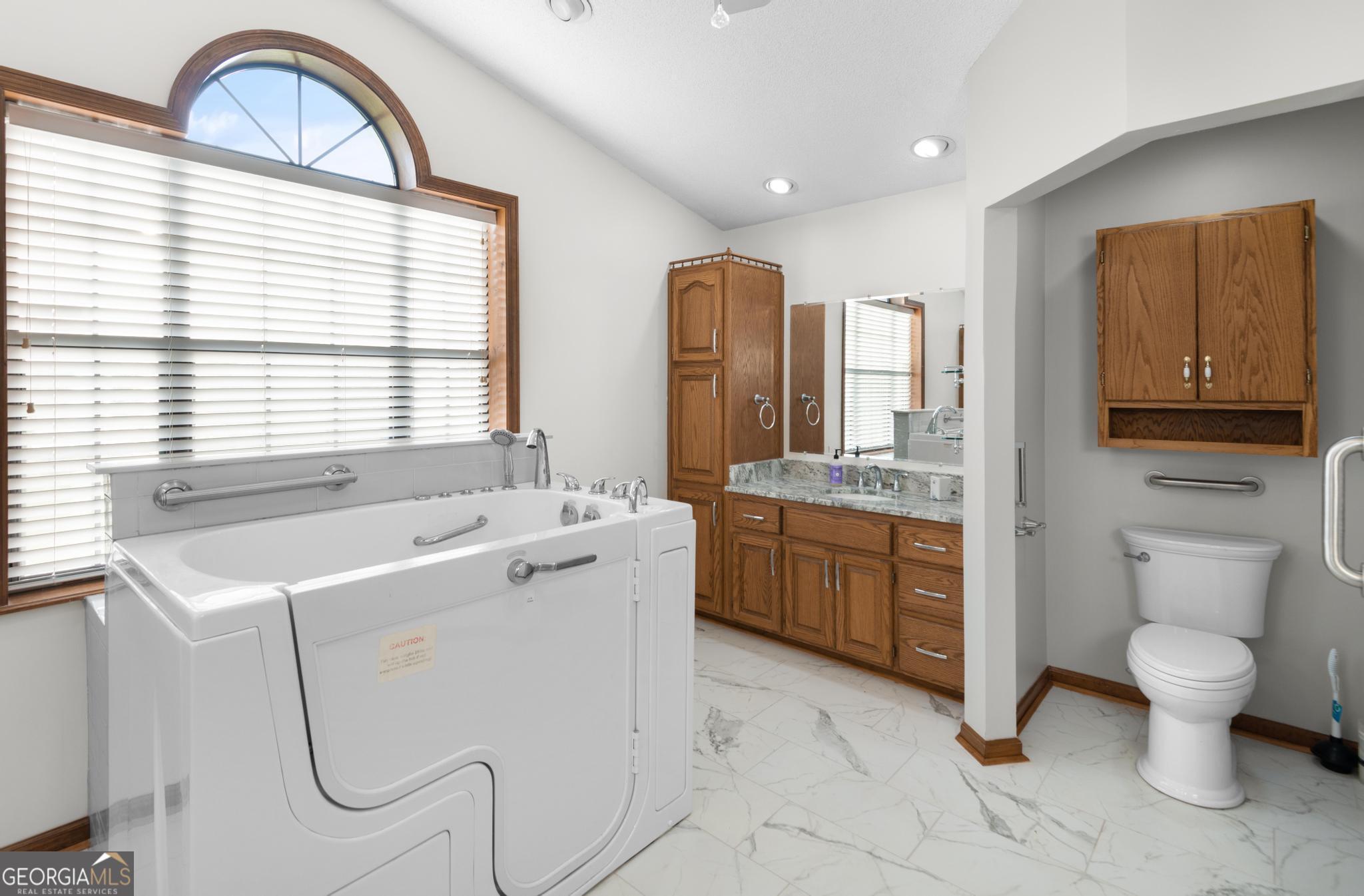 4909 Perry Road Claxton, GA 30417 - Photo 36 of 54 a bathroom with a granite countertop sink toilet and a mirror