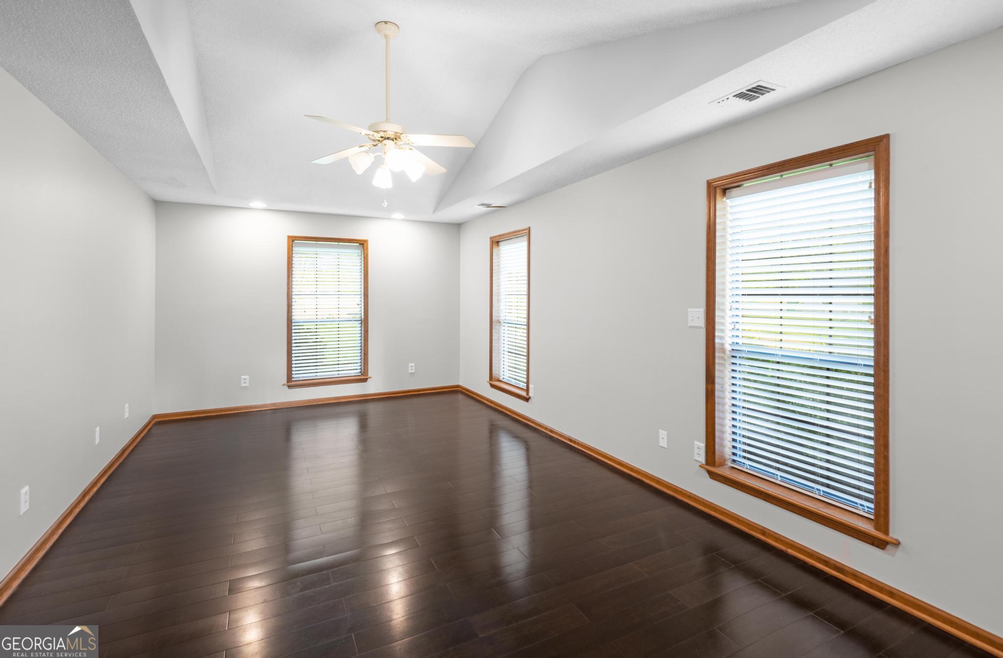 4909 Perry Road Claxton, GA 30417 - Photo 37 of 54 a view of an empty room with wooden floor and a window