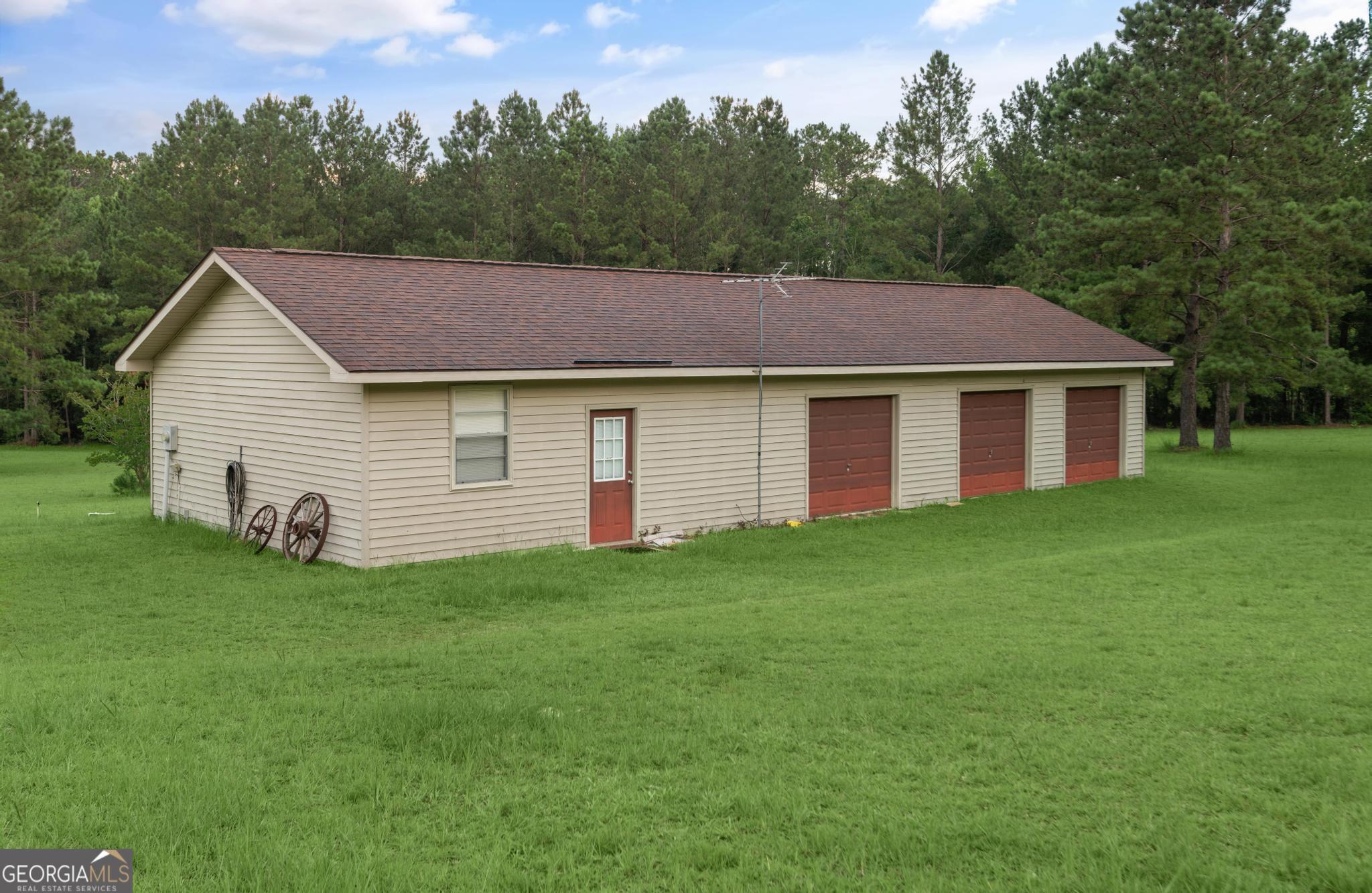 4909 Perry Road Claxton, GA 30417 - Photo 50 of 54 a aerial view of a house next to a yard and large trees