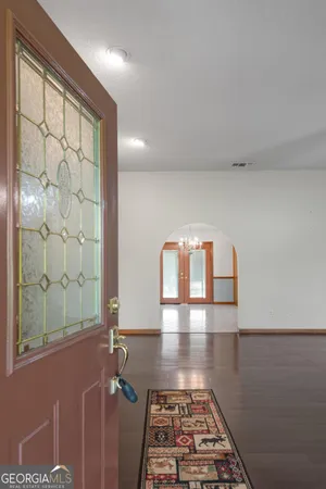 a view of empty room with wooden floor and fireplace