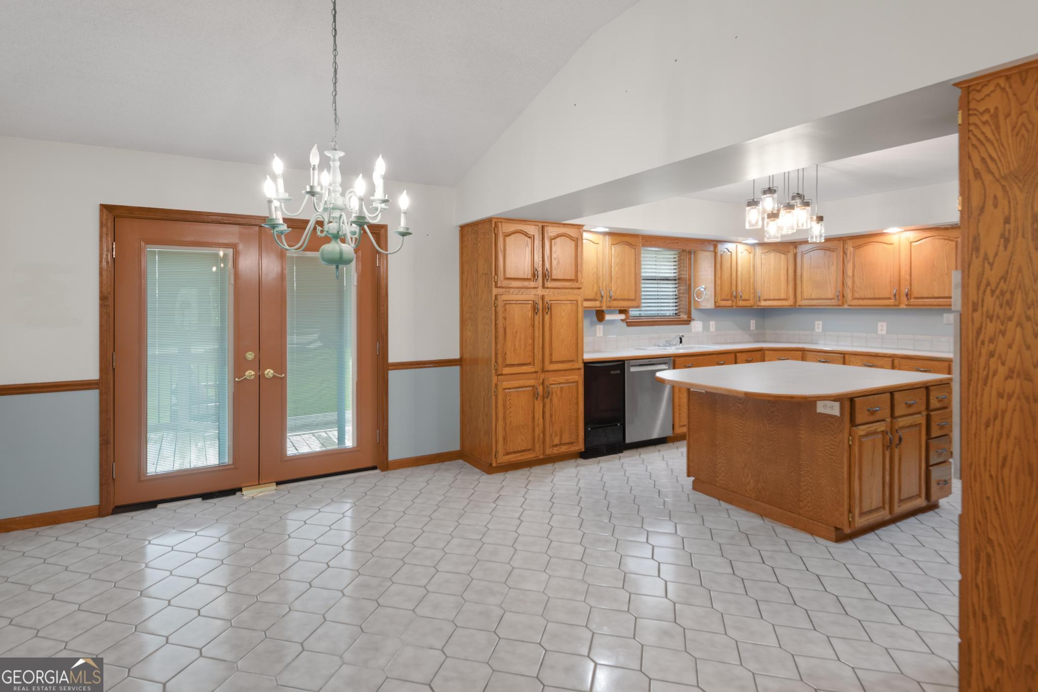 4909 Perry Road Claxton, GA 30417 - Photo 8 of 54 a large kitchen with stainless steel appliances granite countertop a stove and a refrigerator