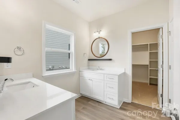 a spacious bathroom with a sink and a large mirror