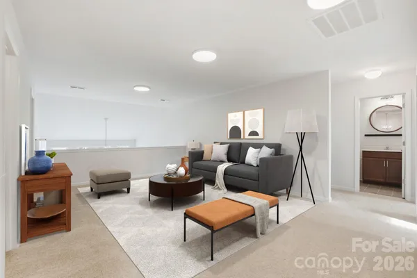 a living room with furniture a rug and a lamp