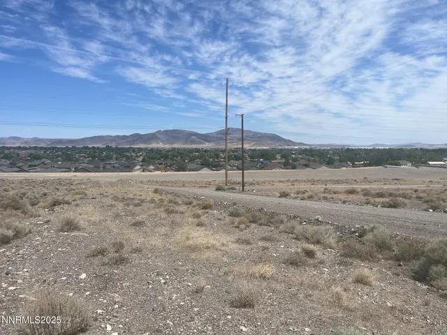 a view of a field with wooden fence