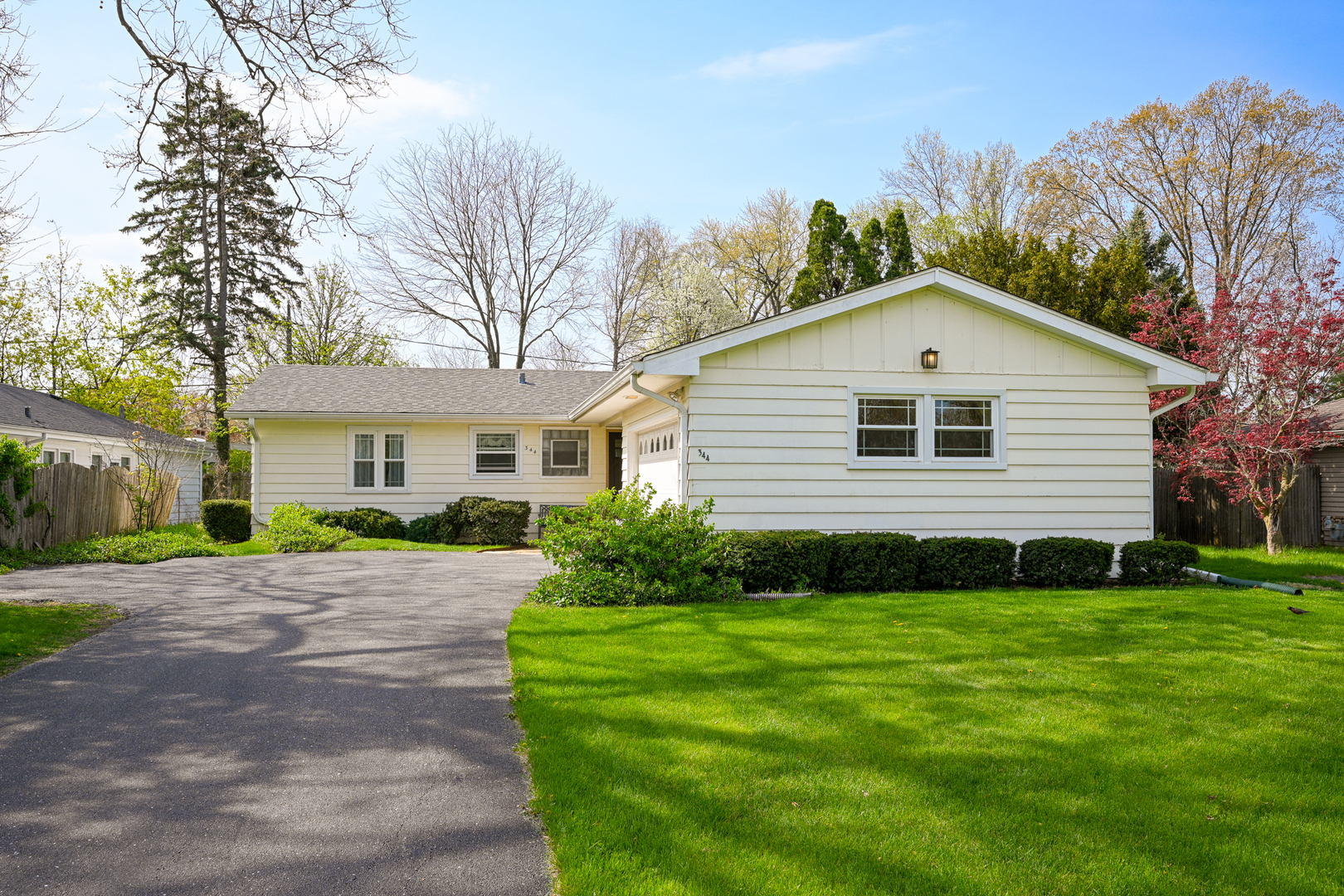 344 Parkway Drive Wheaton, IL 60187 - Photo 1 of 1 a view of a yard in front of a house with plants and large tree