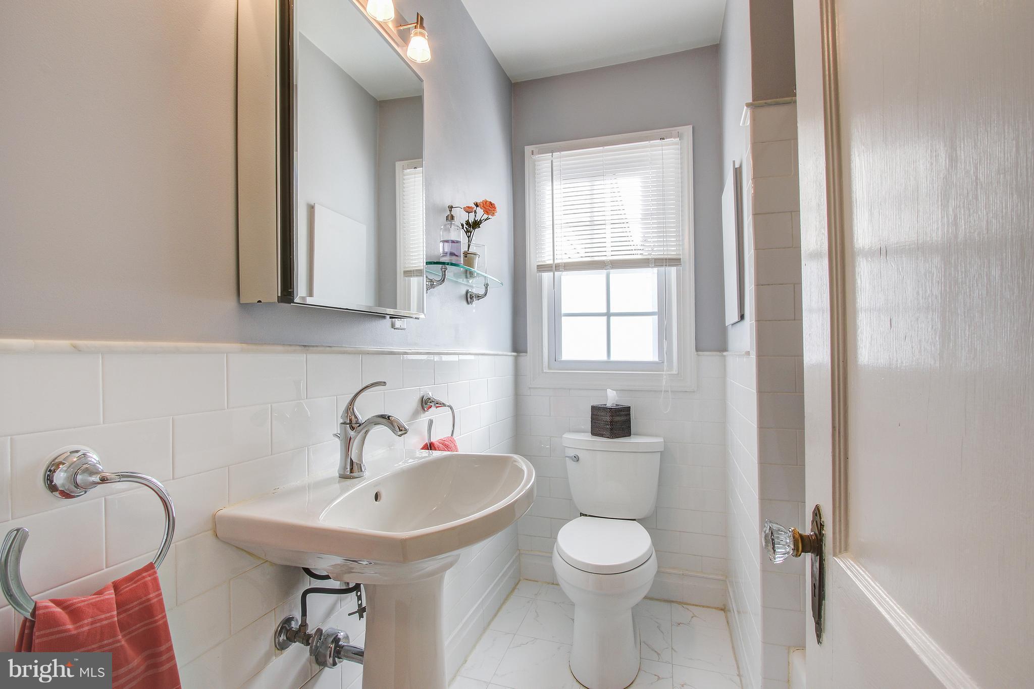9929 Markham Street Silver Spring, MD 20901 - Photo 15 of 29 a bathroom with a sink and a mirror