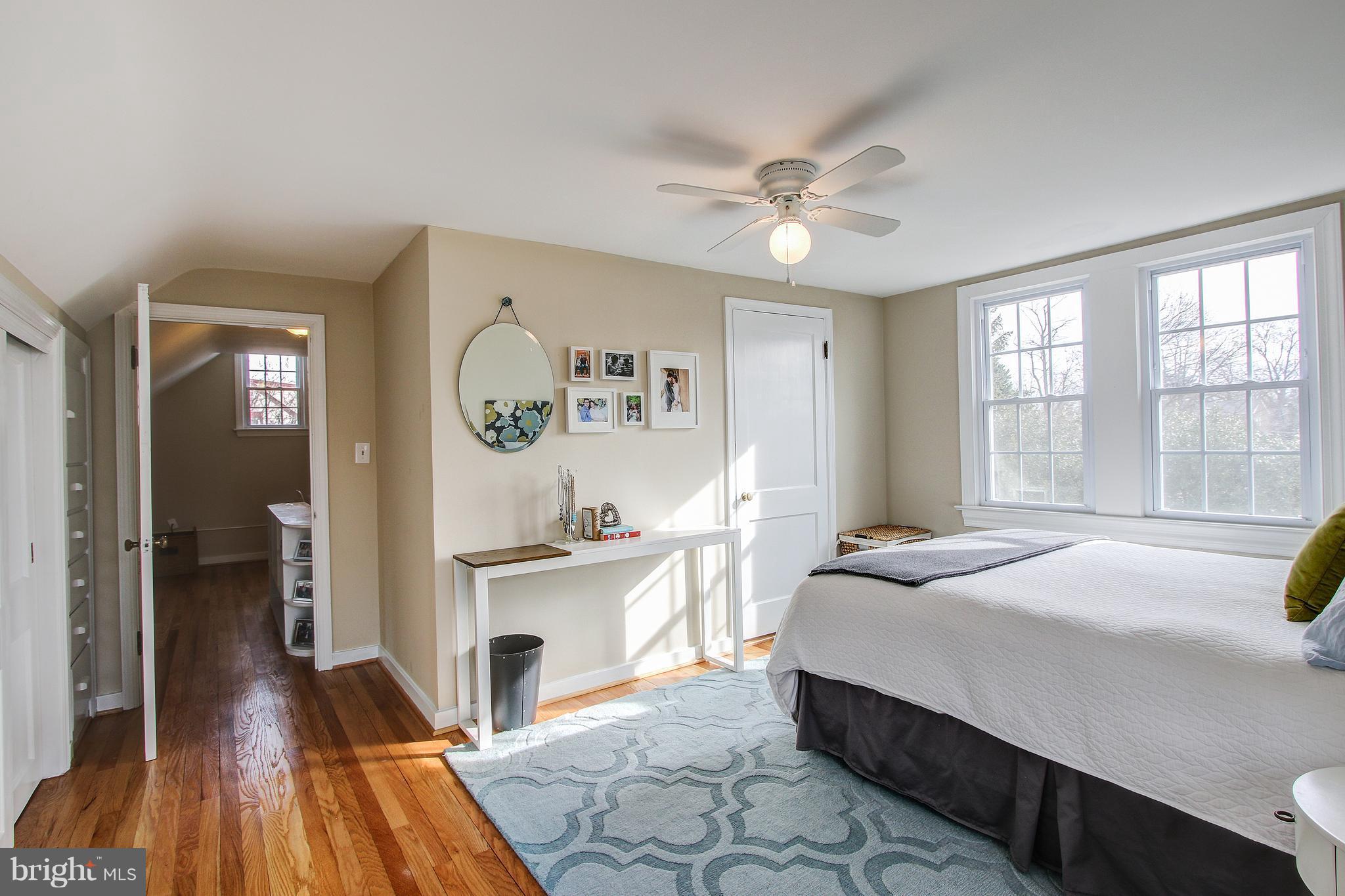 9929 Markham Street Silver Spring, MD 20901 - Photo 18 of 29 a spacious bedroom with a bed and a chandelier