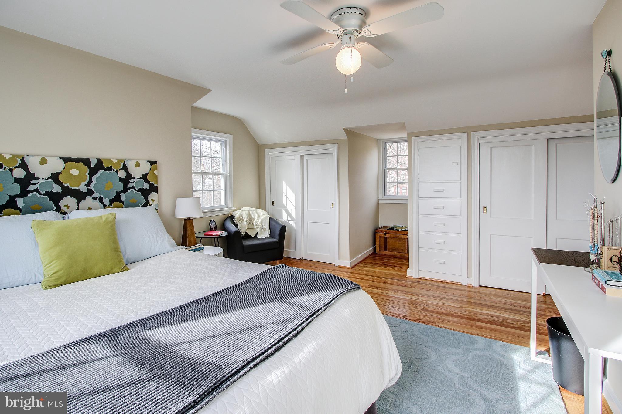 9929 Markham Street Silver Spring, MD 20901 - Photo 19 of 29 a bedroom with a bed and wooden floor