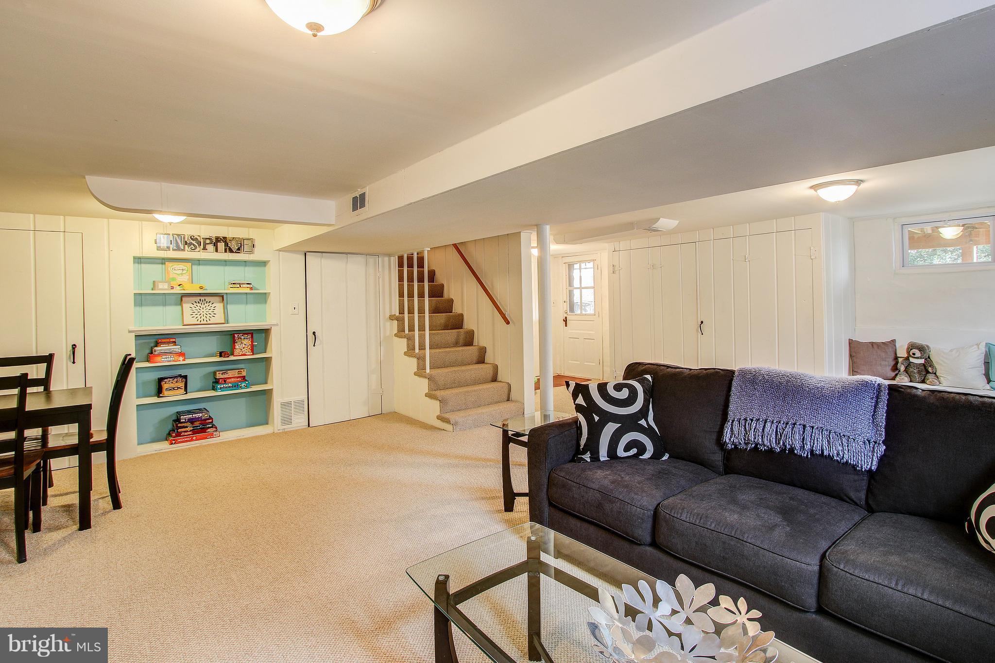 9929 Markham Street Silver Spring, MD 20901 - Photo 23 of 29 a living room with furniture and wooden floor