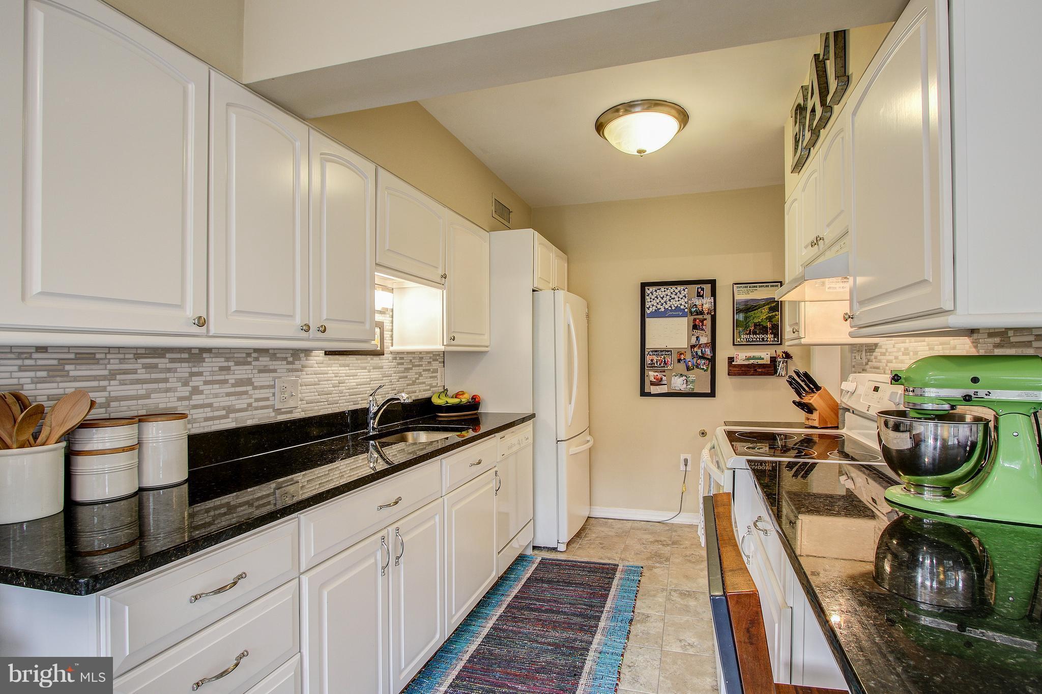9929 Markham Street Silver Spring, MD 20901 - Photo 9 of 29 a kitchen with stainless steel appliances granite countertop a stove a sink and a refrigerator