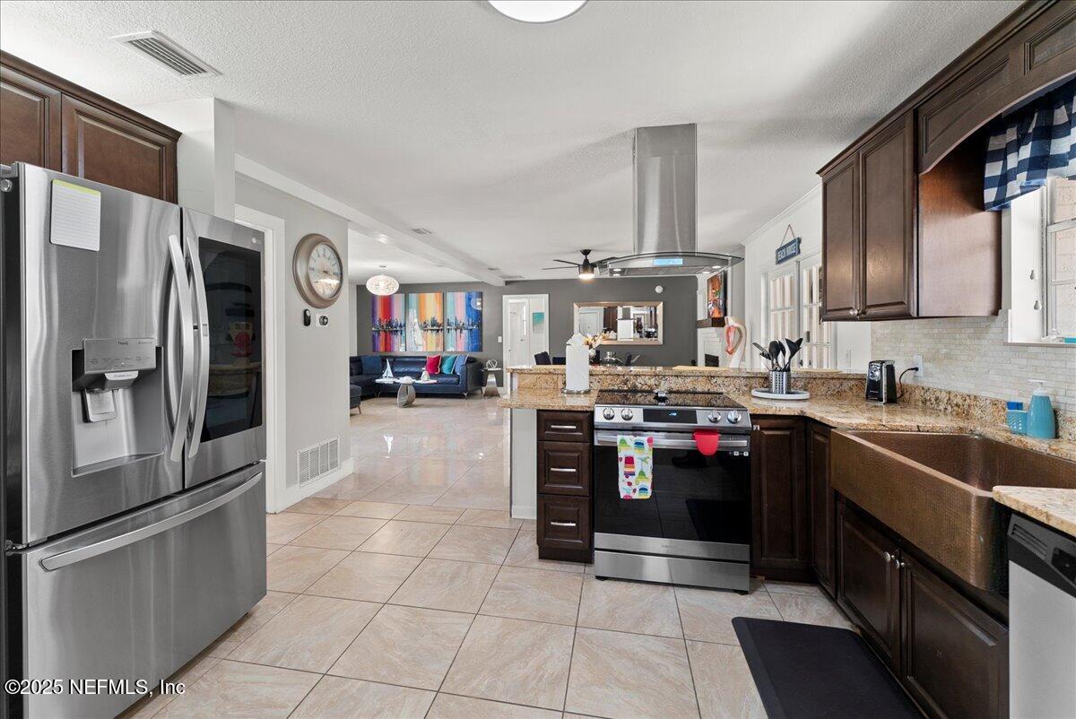 3943 Eunice Road Jacksonville, FL 32250 - Photo 11 of 49 a kitchen with stainless steel appliances granite countertop a refrigerator and a sink