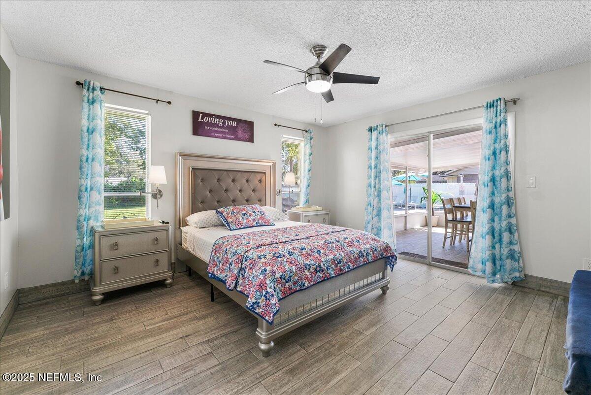 3943 Eunice Road Jacksonville, FL 32250 - Photo 13 of 49 a bedroom with a bed and a large window