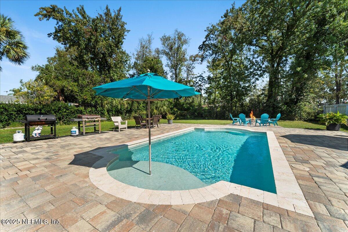 3943 Eunice Road Jacksonville, FL 32250 - Photo 3 of 49 a swimming pool with lots of trees