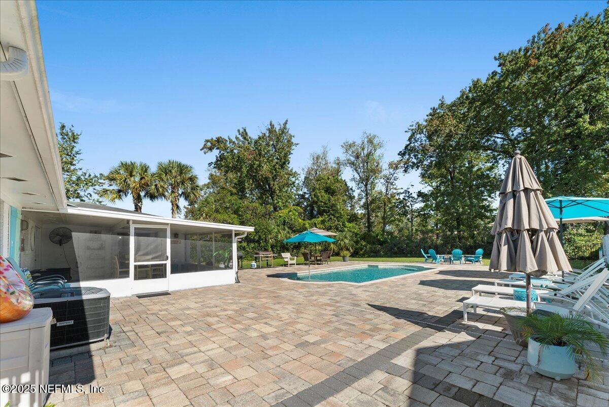 3943 Eunice Road Jacksonville, FL 32250 - Photo 32 of 49 a view of a patio with table and chairs a barbeque with wooden fence and plants