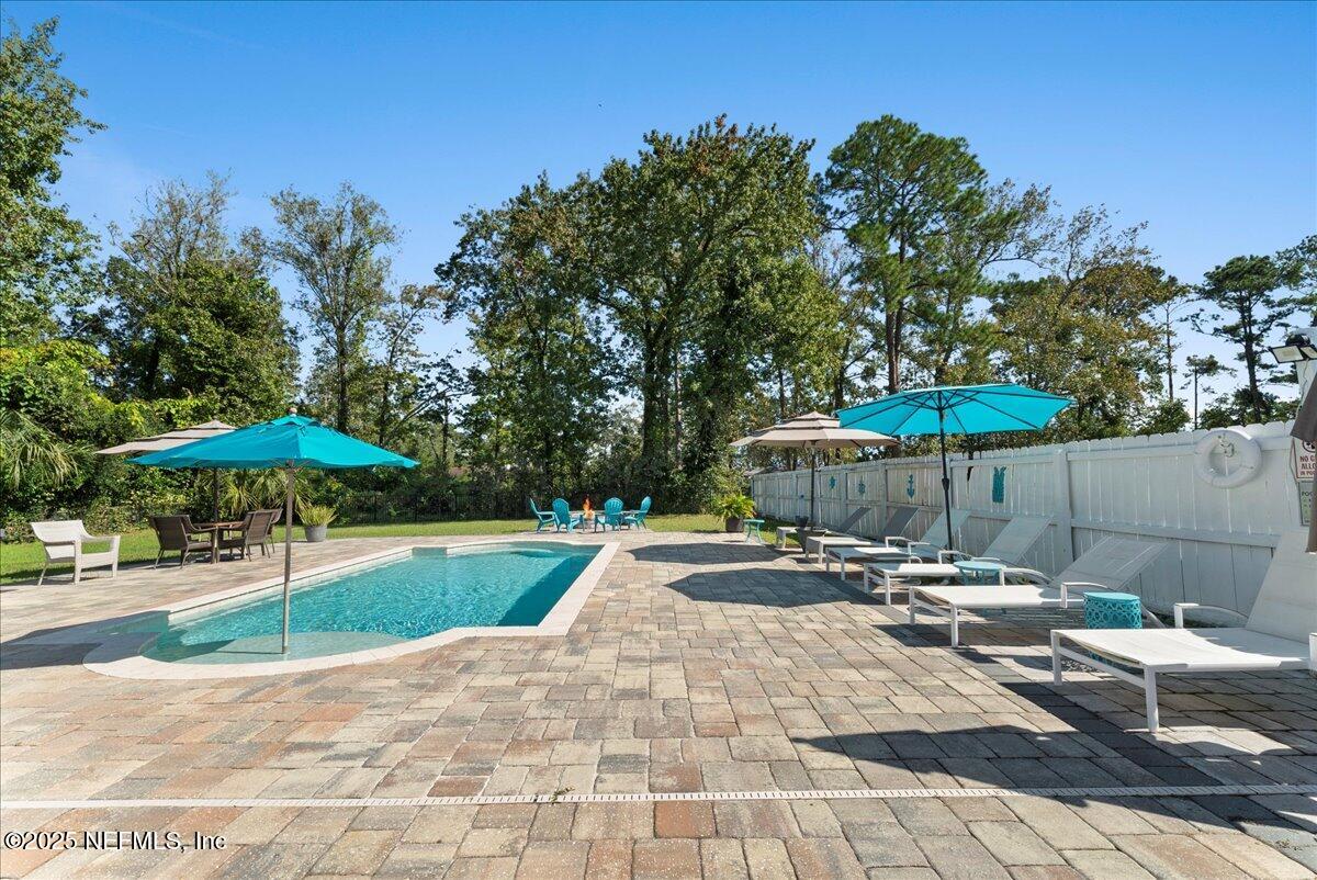 3943 Eunice Road Jacksonville, FL 32250 - Photo 33 of 49 a view of a backyard with a patio and fire pit