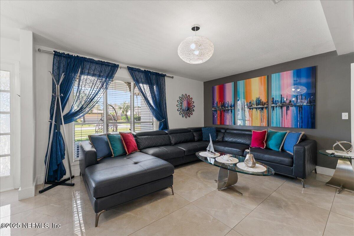 3943 Eunice Road Jacksonville, FL 32250 - Photo 6 of 49 a living room with furniture and a large window