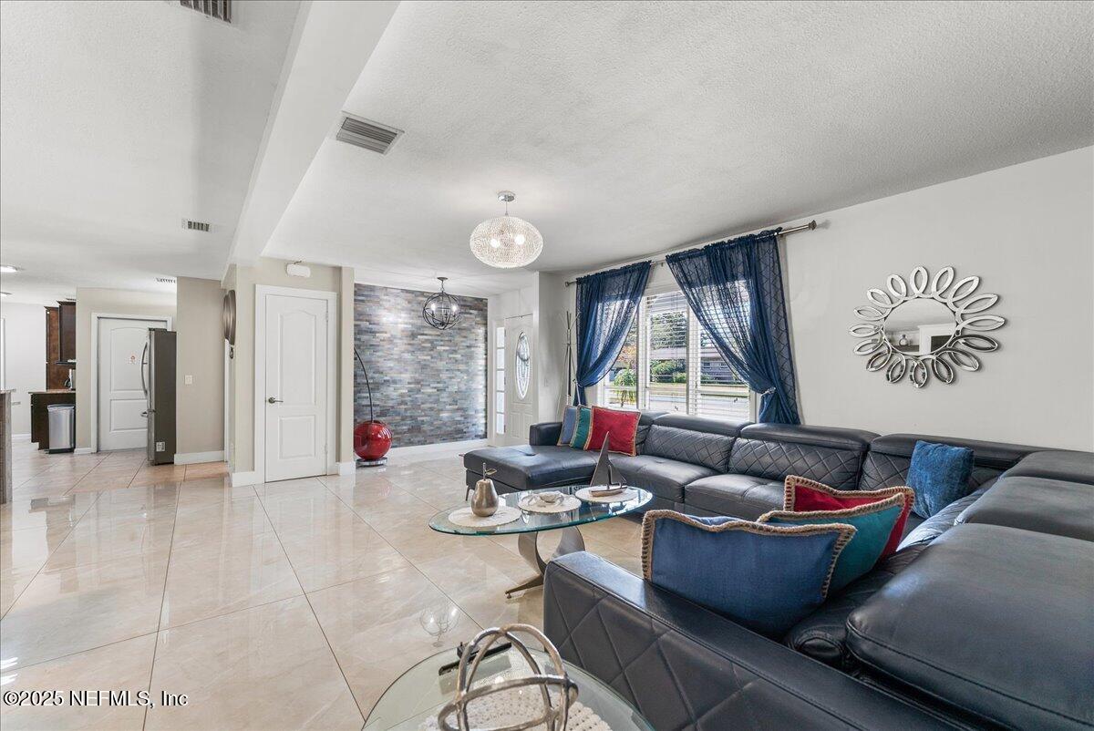 3943 Eunice Road Jacksonville, FL 32250 - Photo 7 of 49 a living room with furniture and a large window