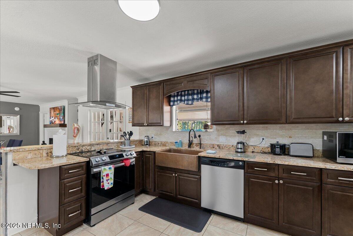 3943 Eunice Road Jacksonville, FL 32250 - Photo 10 of 49 a kitchen with a sink a stove and cabinets
