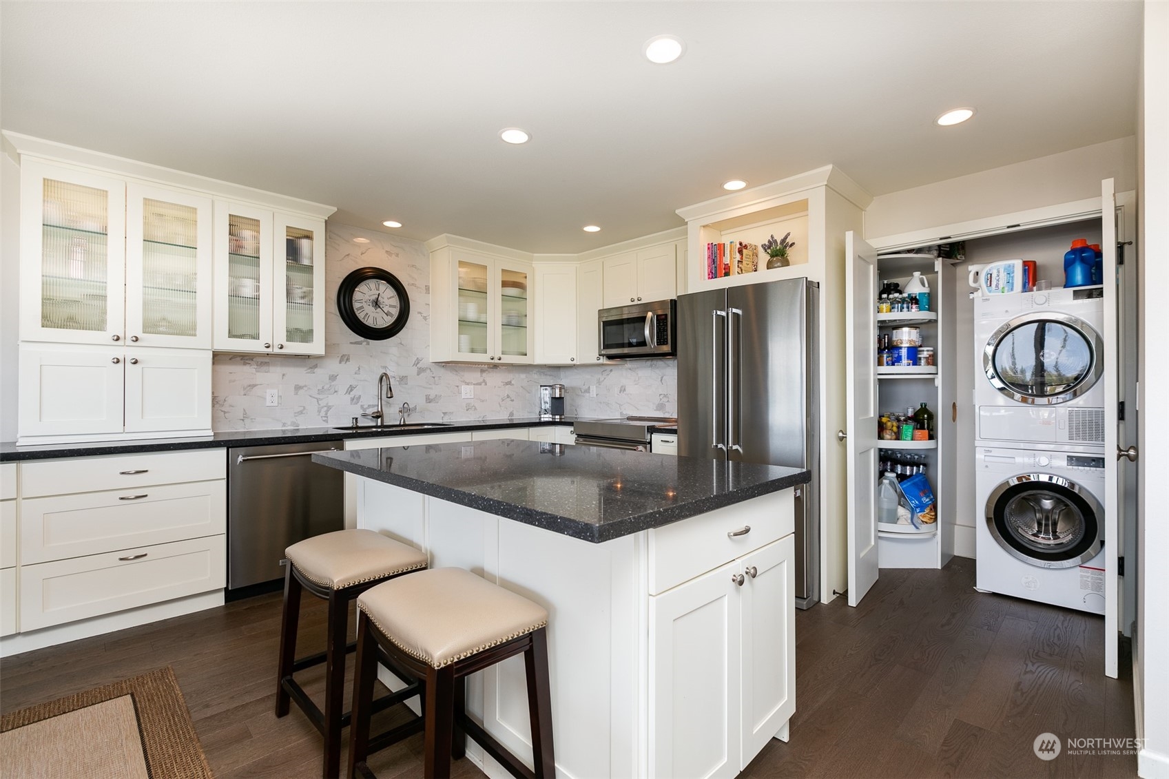 655 Main Street, Unit 301 Edmonds, WA 98020 - Photo 11 of 28 a kitchen with cabinets and stainless steel appliances