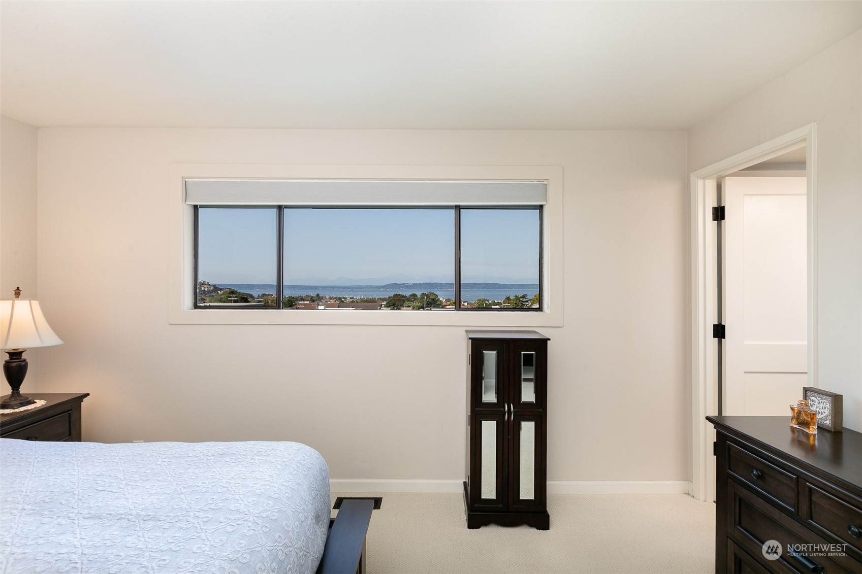 655 Main Street, Unit 301 Edmonds, WA 98020 - Photo 14 of 28 a bedroom with a bed and a window