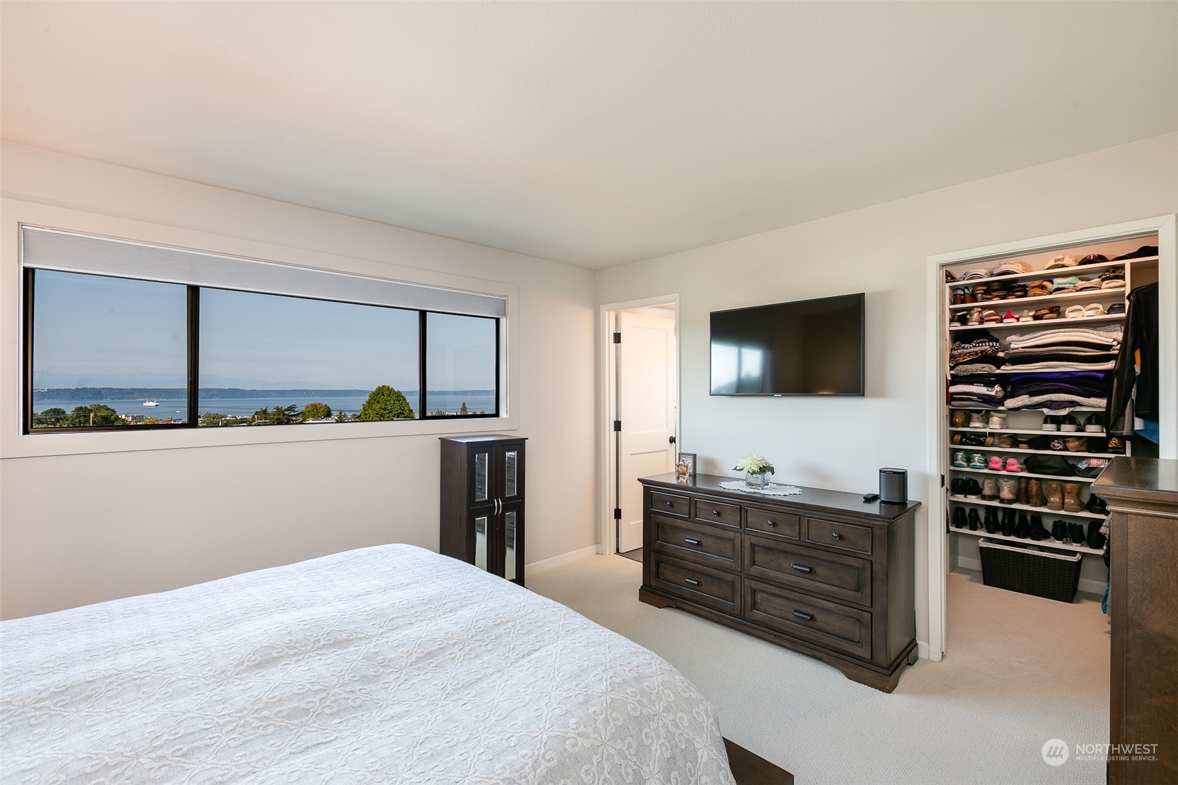 655 Main Street, Unit 301 Edmonds, WA 98020 - Photo 15 of 28 a bedroom with a bed and a flat screen tv