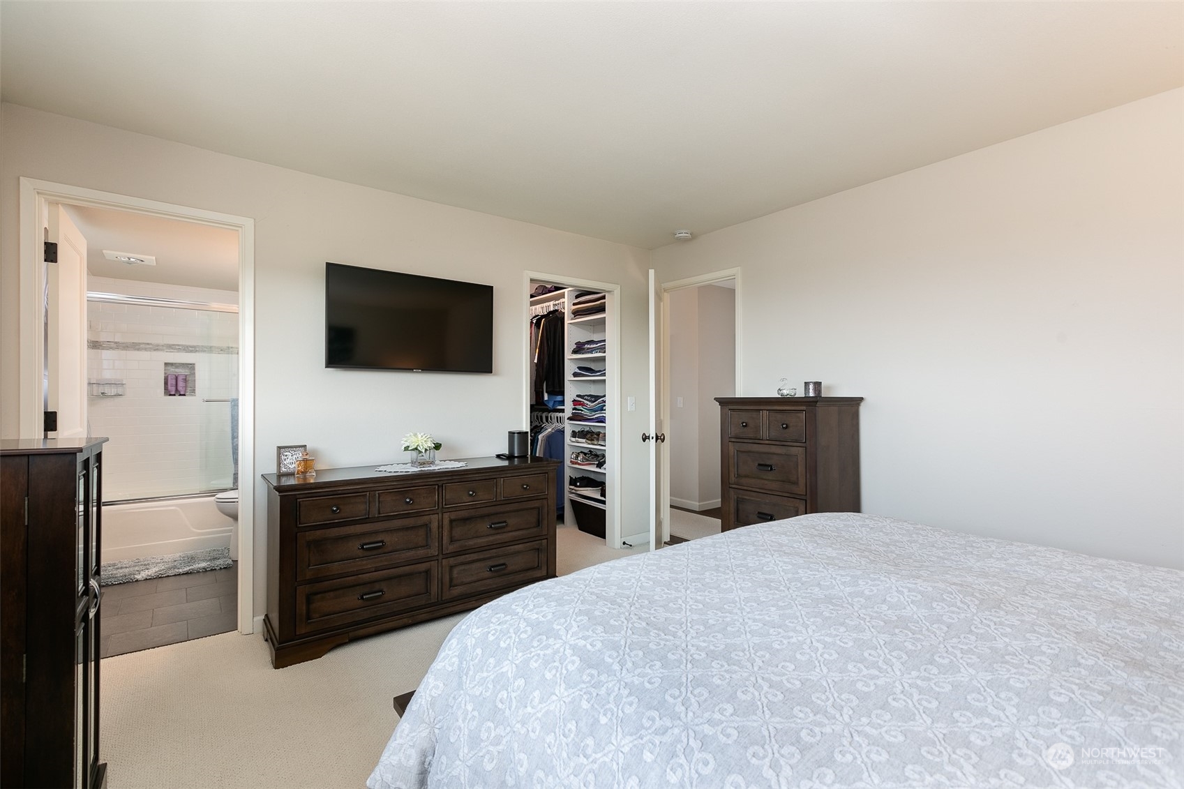 655 Main Street, Unit 301 Edmonds, WA 98020 - Photo 16 of 28 a bedroom with a bed and flat screen tv