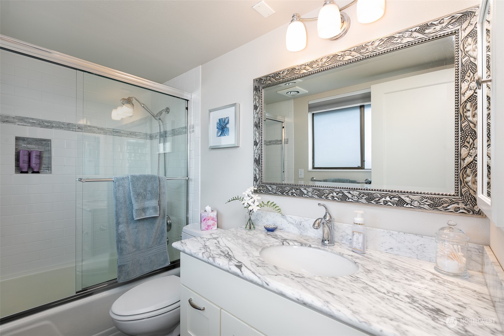 655 Main Street, Unit 301 Edmonds, WA 98020 - Photo 17 of 28 a bathroom with a granite countertop sink a toilet and shower