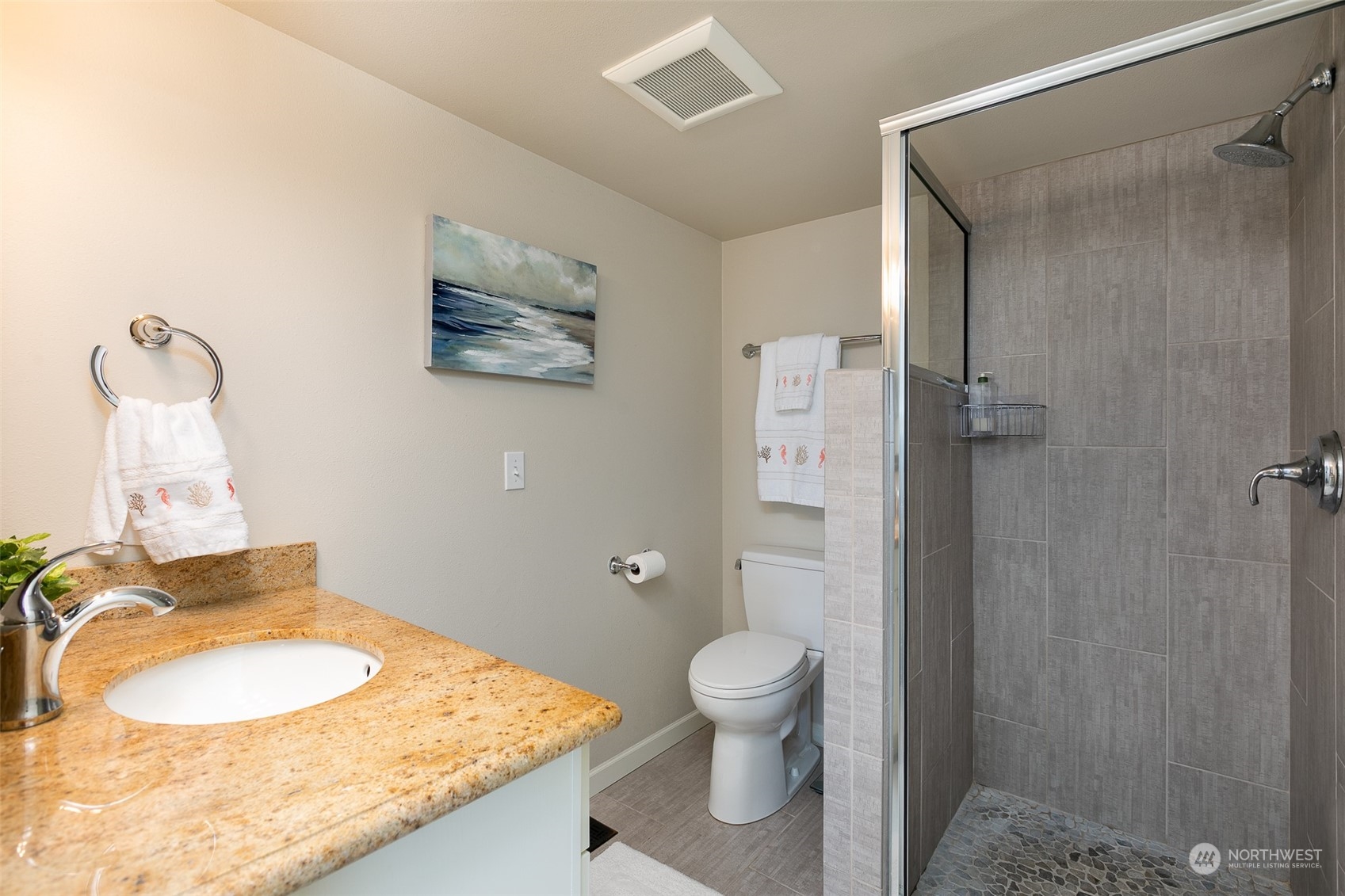 655 Main Street, Unit 301 Edmonds, WA 98020 - Photo 20 of 28 a bathroom with a granite countertop sink toilet and shower