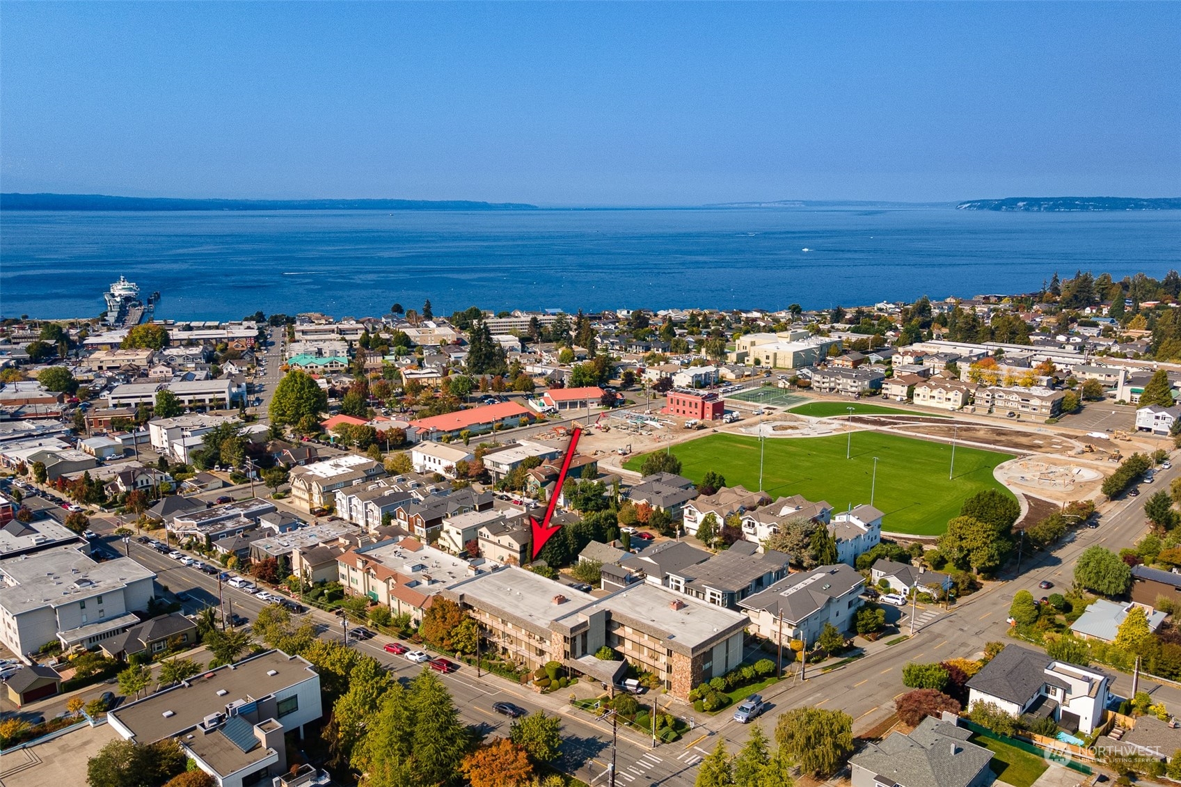 655 Main Street, Unit 301 Edmonds, WA 98020 - Photo 25 of 28 an aerial view of a building with an outdoor space and seating
