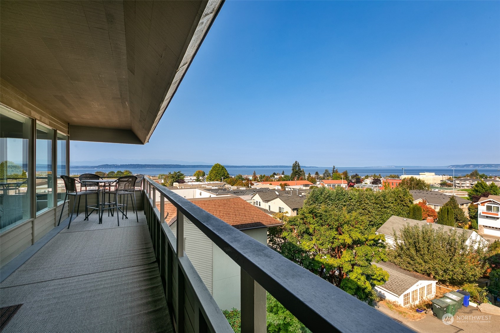 655 Main Street, Unit 301 Edmonds, WA 98020 - Photo 3 of 28 a view of a balcony with wooden floor and outdoor seating