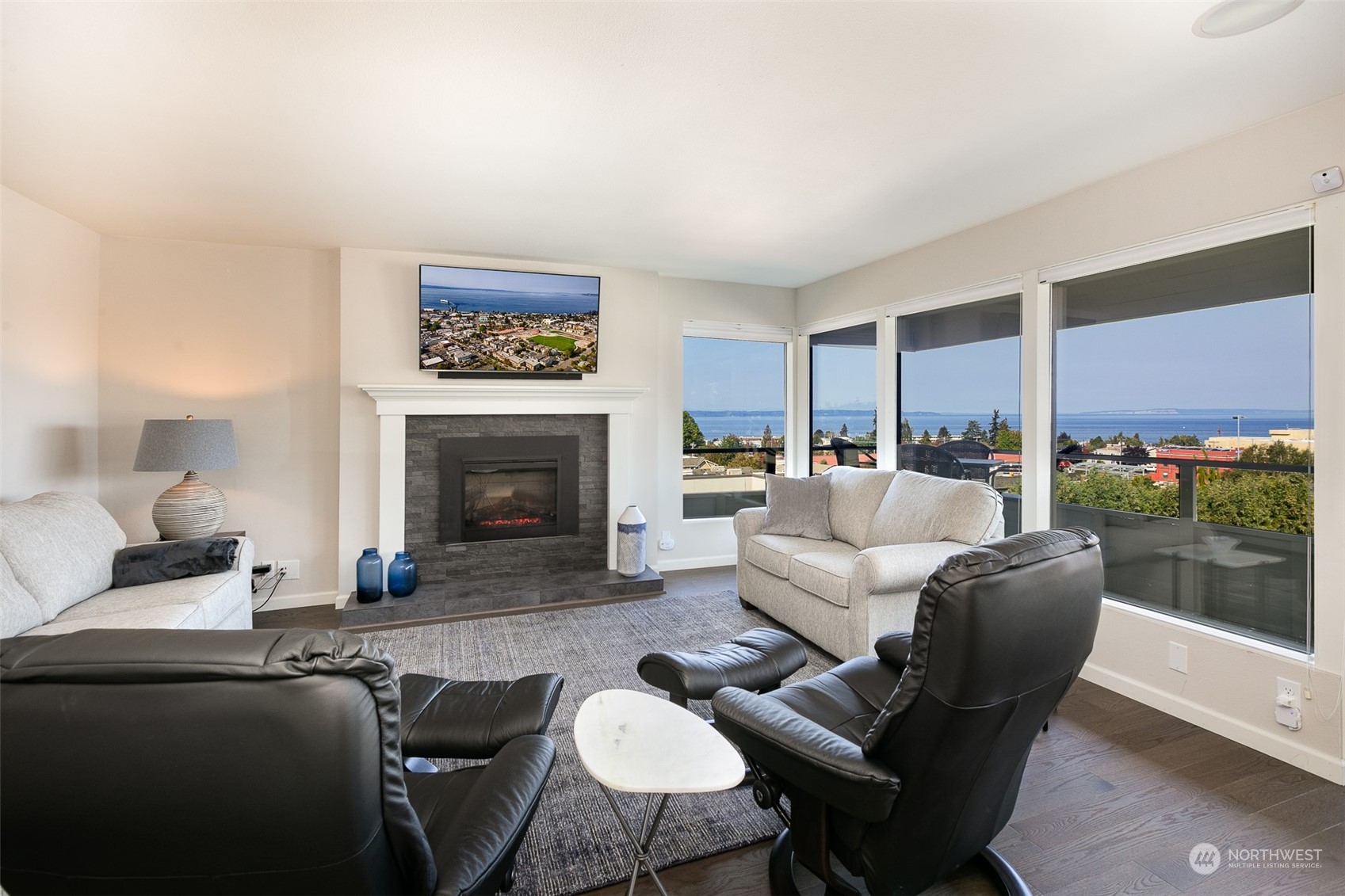 655 Main Street, Unit 301 Edmonds, WA 98020 - Photo 8 of 28 a living room with furniture dining table and a fireplace