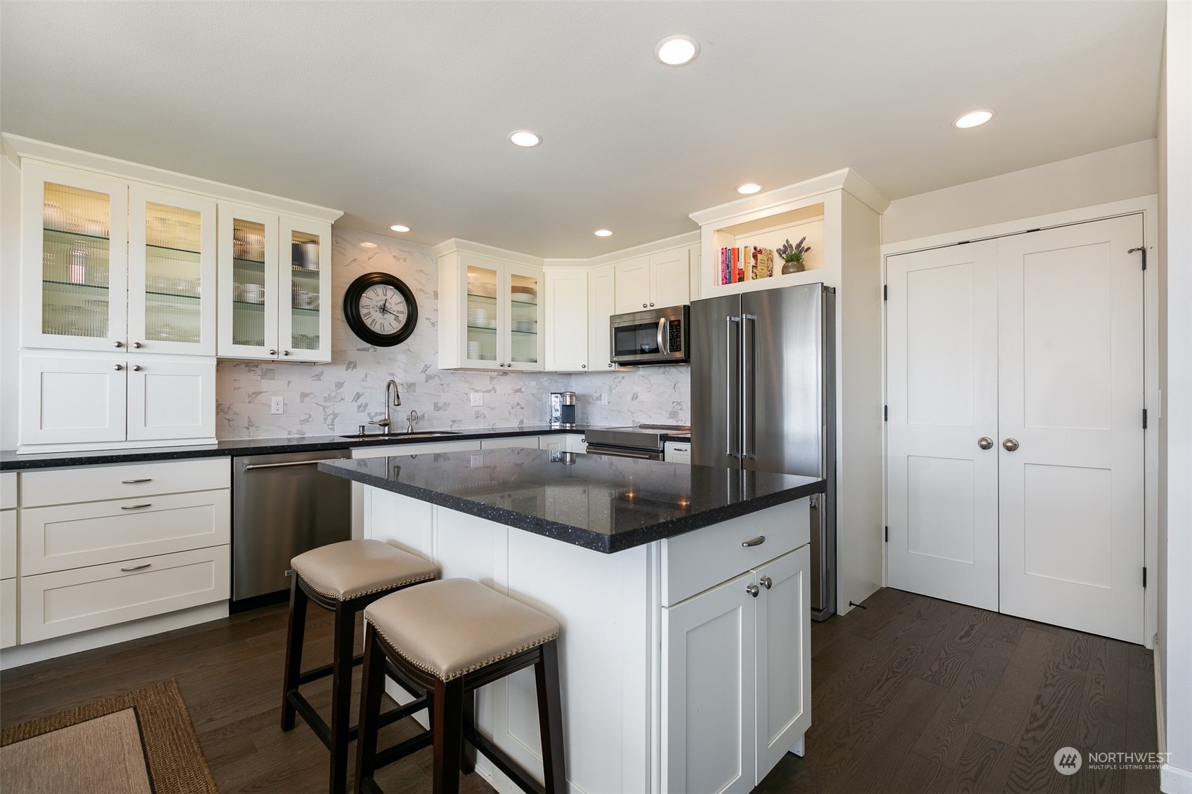 655 Main Street, Unit 301 Edmonds, WA 98020 - Photo 10 of 28 a kitchen with a refrigerator a stove and a sink