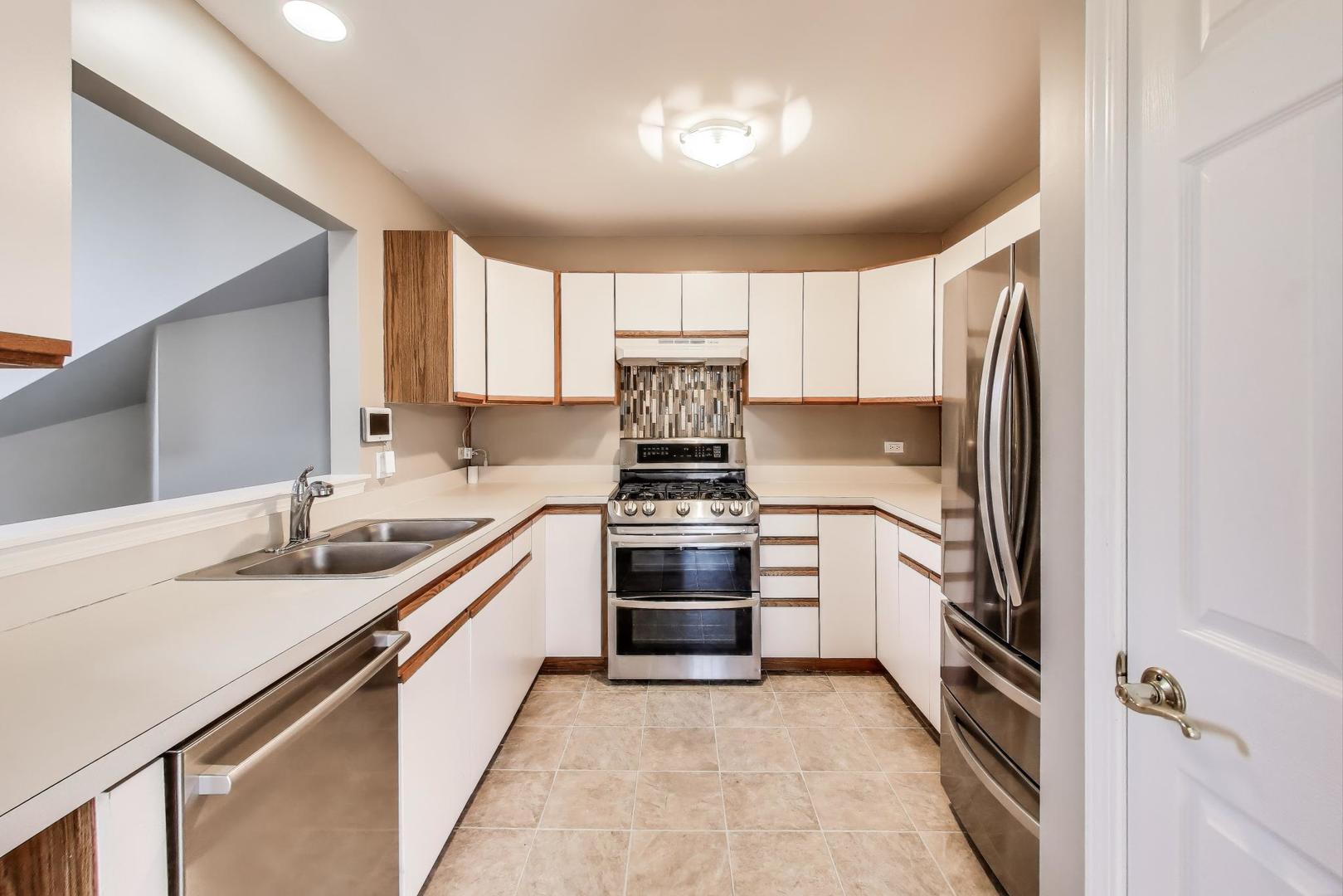 914 Prospect Court, Unit 914 Naperville, IL 60540 - Photo 12 of 38 a kitchen with a stove sink and refrigerator