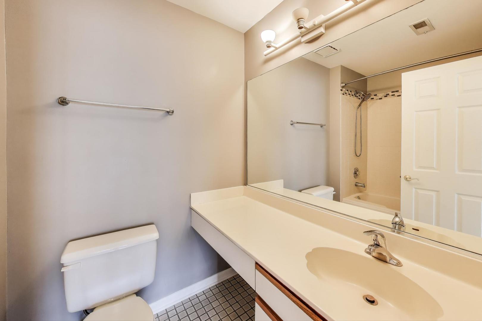 914 Prospect Court, Unit 914 Naperville, IL 60540 - Photo 21 of 38 a bathroom with a sink a toilet and shower