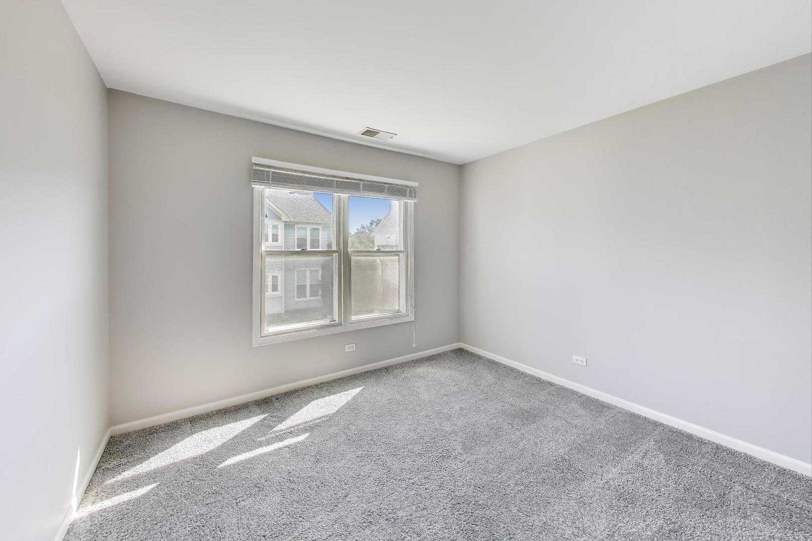 914 Prospect Court, Unit 914 Naperville, IL 60540 - Photo 22 of 38 a view of an empty room with a window