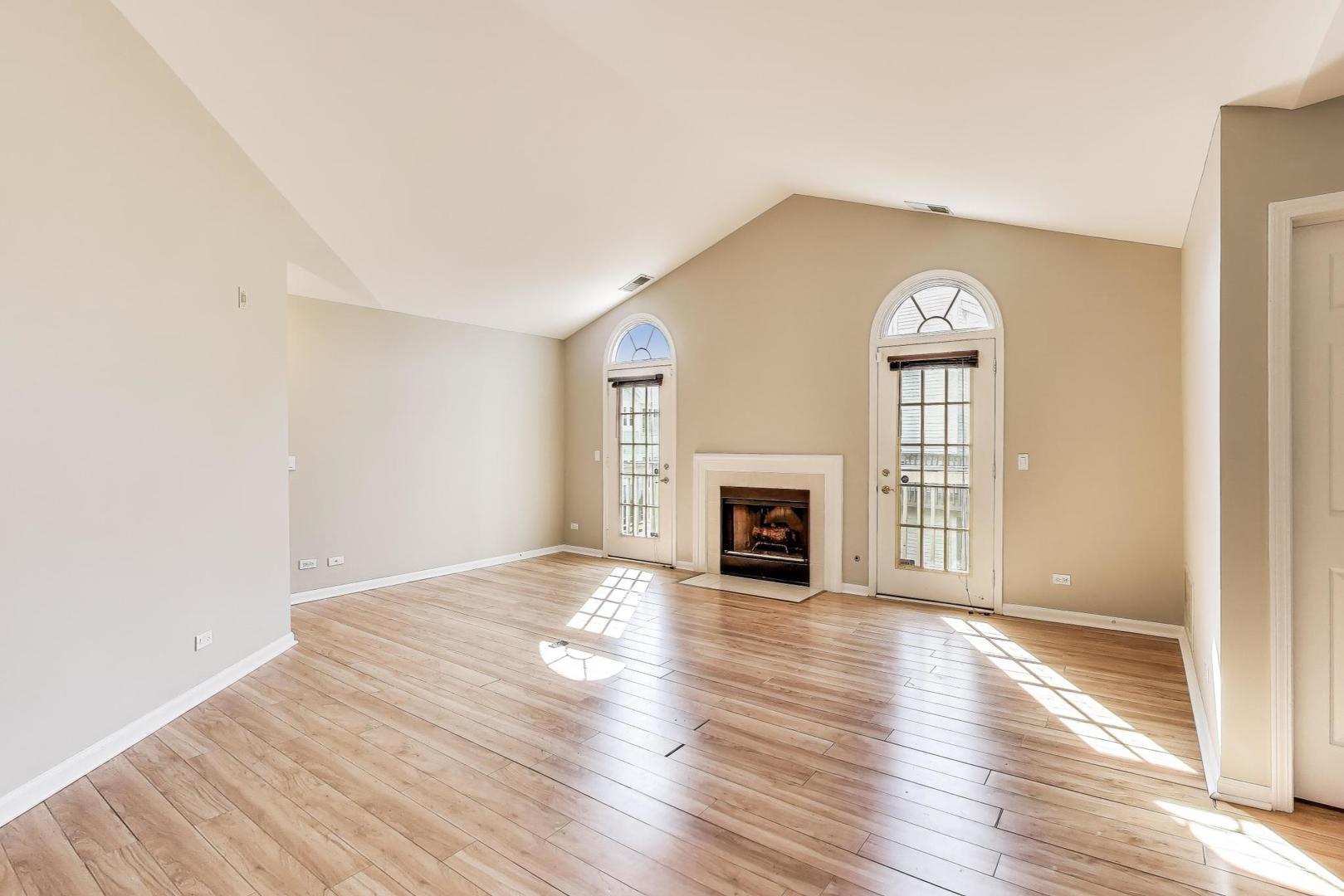 914 Prospect Court, Unit 914 Naperville, IL 60540 - Photo 4 of 38 an empty room with wooden floor fireplace and windows