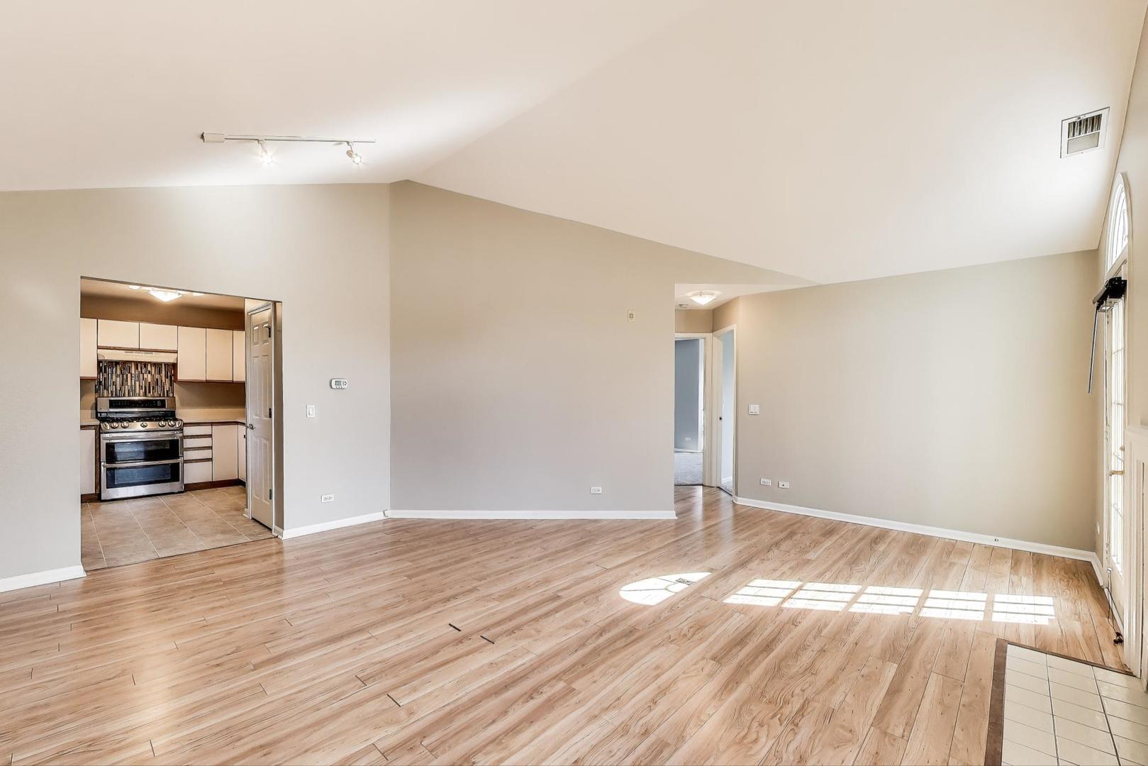 914 Prospect Court, Unit 914 Naperville, IL 60540 - Photo 8 of 38 a view of an empty room with wooden floor