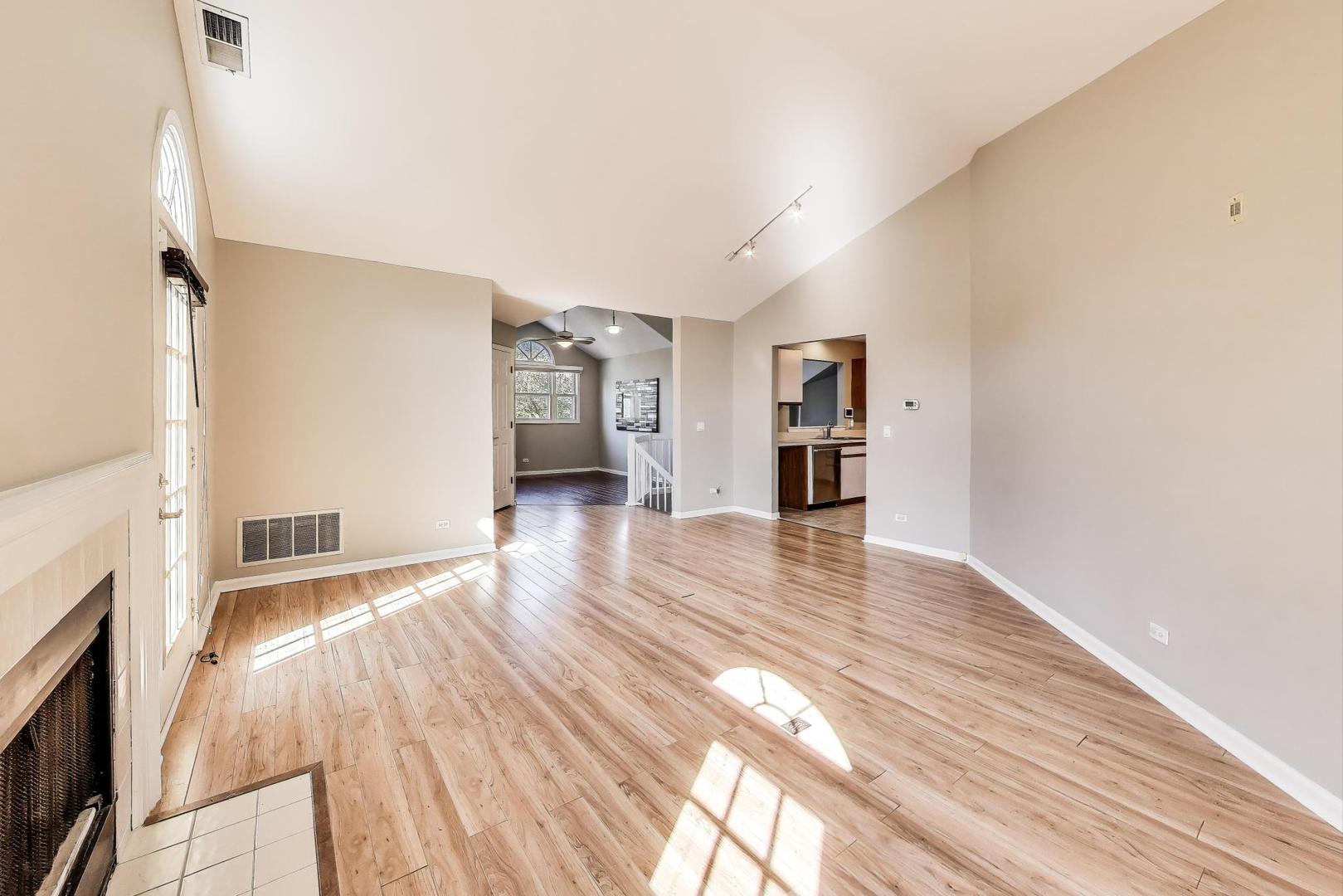 914 Prospect Court, Unit 914 Naperville, IL 60540 - Photo 9 of 38 a view of empty room with wooden floor and a window