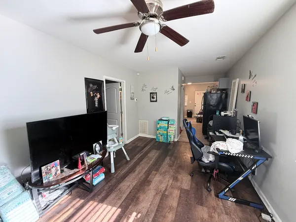 a living room with furniture and a flat screen tv