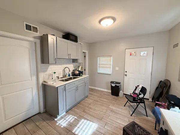 a kitchen with stainless steel appliances granite countertop a stove refrigerator and a sink