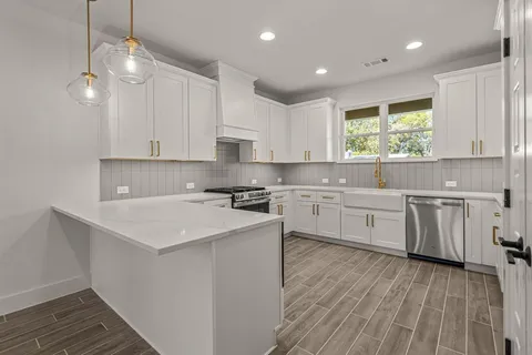 a kitchen with a sink window and cabinets