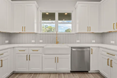a kitchen with white cabinets and white appliances