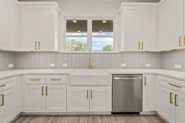 a kitchen with white cabinets and white appliances