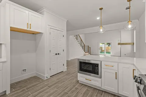 a kitchen with white cabinets and white appliances