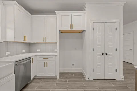 a view of a kitchen with white cabinets