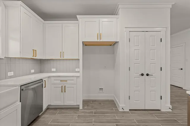 a view of a kitchen with white cabinets