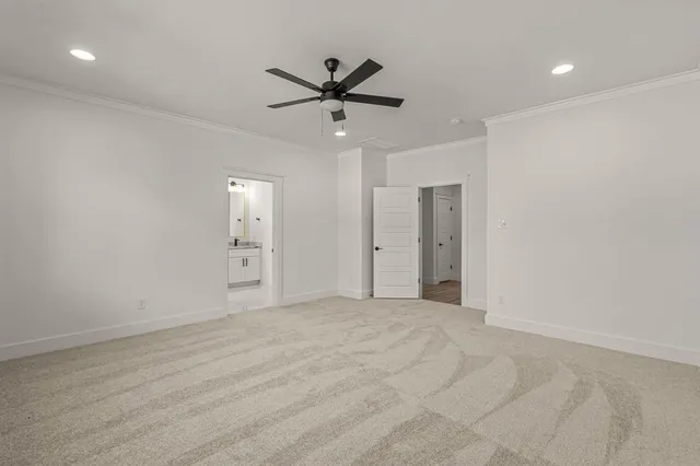 a view of empty room with wooden floor and ceiling fan