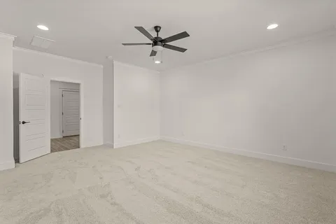 an empty room with closet and windows