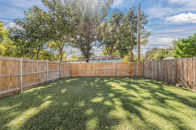 a view of yard with wooden fence