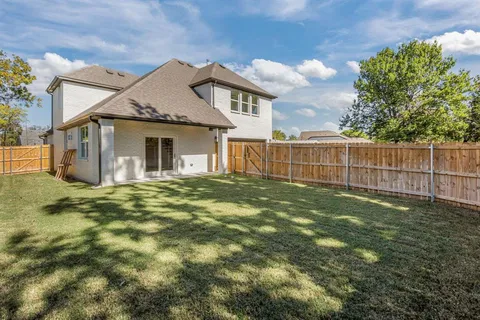 a view of a house with a yard and sitting area